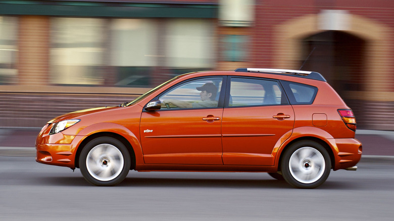An orange Pontiac Vibe driving