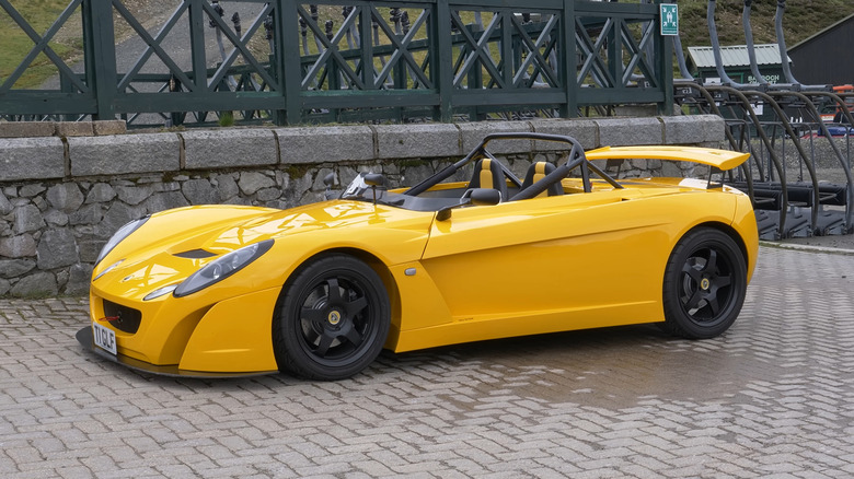 A yellow Lotus 2-Eleven parked