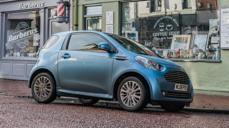 A blue Aston Martin Cygnet parked