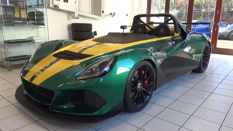 A green and yellow 2017 Lotus 3-Eleven parked