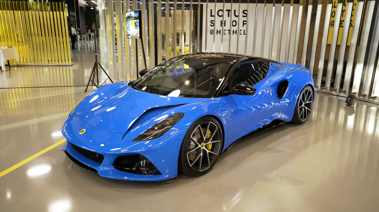 A blue 2022 Lotus Emira in a showroom