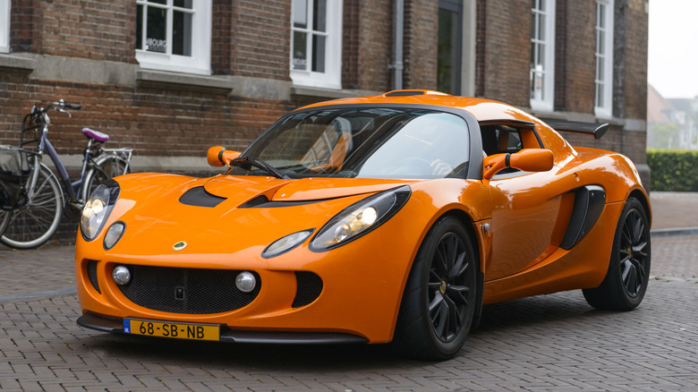 An orange Lotus Exige parked