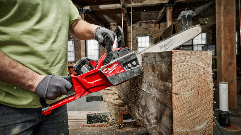 Worker uses Milwaukee 16 inch Chainsaw