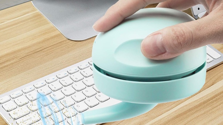 A USB vacuum cleaner over a keyboard.