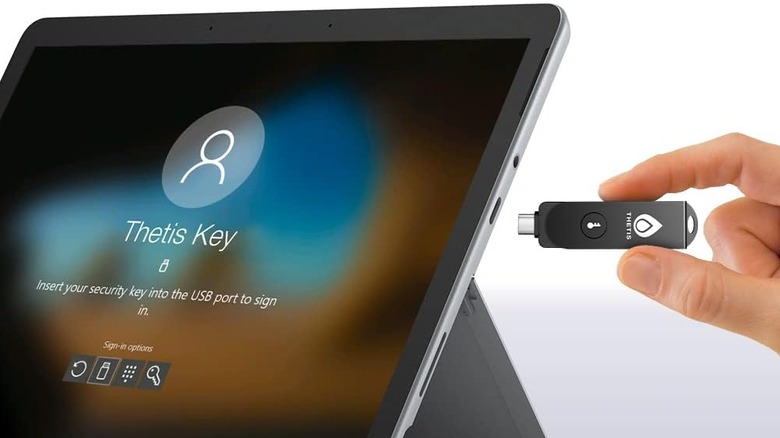 A USB security key getting plugged into a tablet.