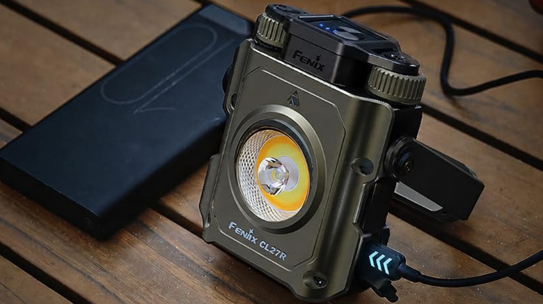 A Fenix CL27R being charged by a power bank.