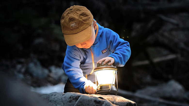 A small child charging the Goal Zero Lighthouse 600 with its unique hand crank.