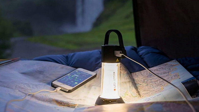 A Ledlenser ML6 in a tent with a waterfall in the background.