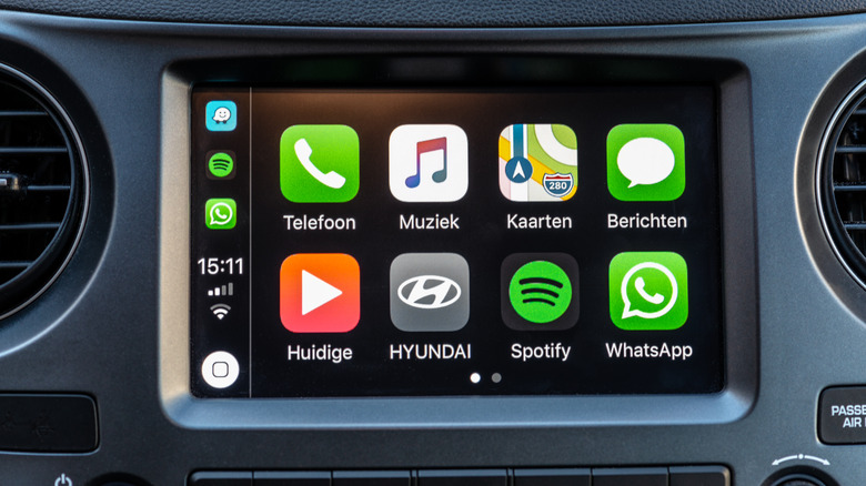 WhatsApp icon with other apps on the Apple CarPlay interface on a car's infotainment screen