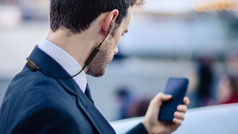 A man wearing the Panasonic ErgoFit earbuds.
