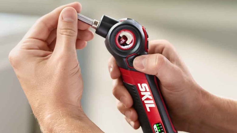 Person adjusting head of electric screwdriver