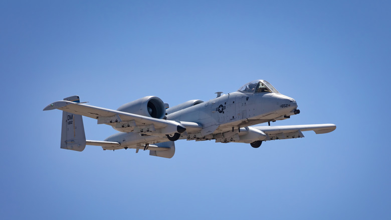 A fairchild republic A10 Warthog performing an aerial move against a clear blue sky
