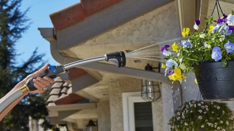 person using Niagara multipattern watering wand to water flowers