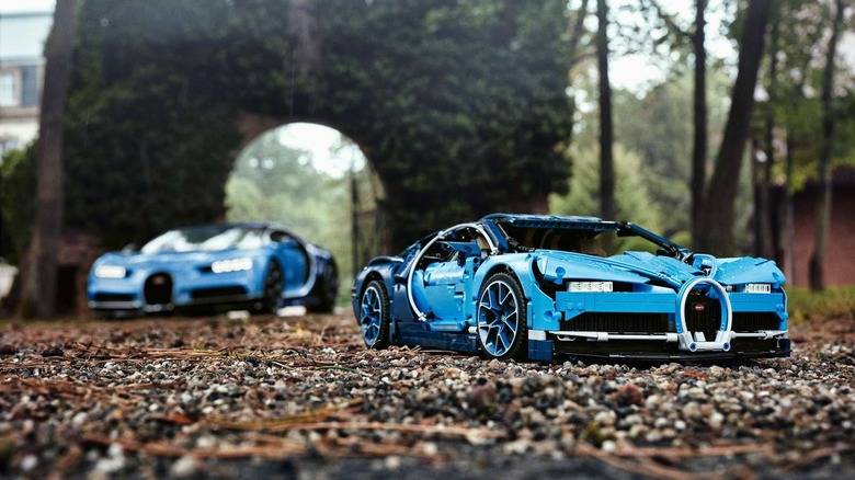 Two LEGO Technic Bugatti Chirons racing outdoors.