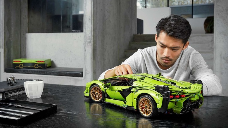 A man applying the finishing touches to the LEGO Technic Lamborghini Sián FKP 37.