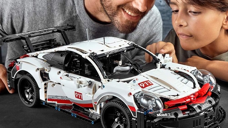 A father and son building the Porsche 911 RSR LEGO Technic set.