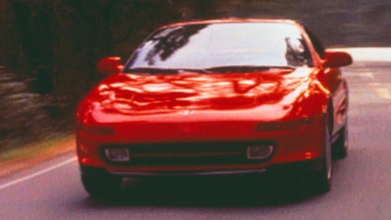 Red second gen Toyota MR2 driving