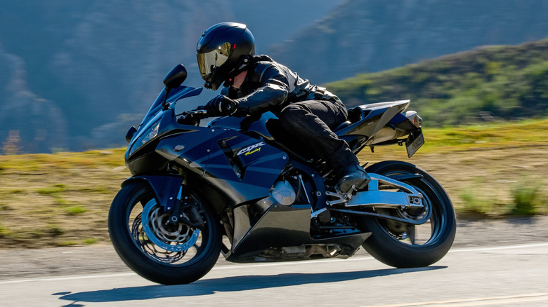 Rider wearing a black AGV helmet on a Honda CBR600RR