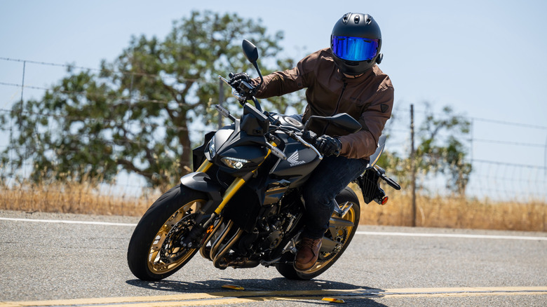 Rider on the Honda CB1000 Hornet SP wearing an Arai Helmet, REV'IT! jacket and gloves, Dainese pants, and Alpinestars shoes