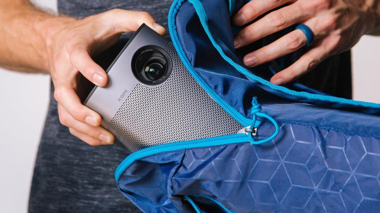 Slipping the XGIMI Halo+ into a backpack.