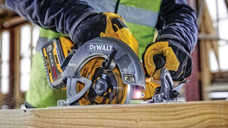 A worker using a circular saw to cut wood