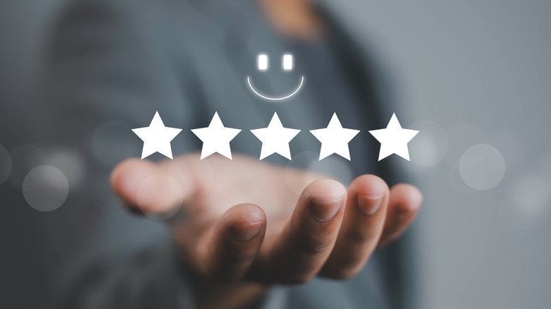 Holographic image of five stars and a smiley face.