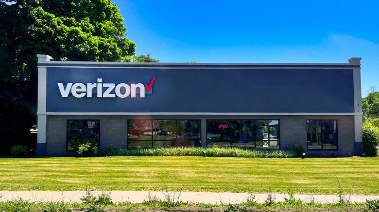 A modern Verizon Wireless store with a green lawn and blue sky