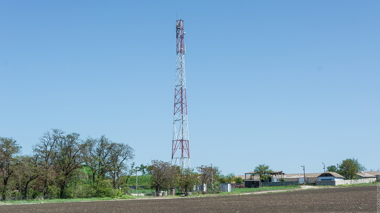 A cell phone tower against a blue sky