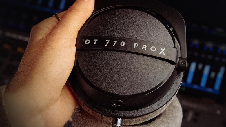 Holding one cup of the Beyerdynamic DT 770 Pro X headphones.