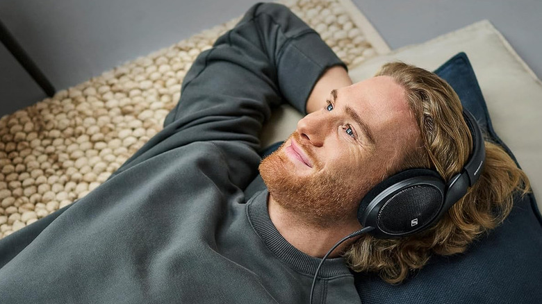 A man listening to the Sennheiser HD 560Ss with a smile on his face.
