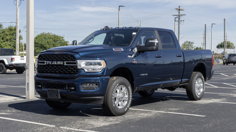 A RAM 2500 in navy blue parked in a dealer lot.