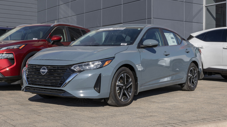 Grey Nissan Sentra in a dealership parking lot