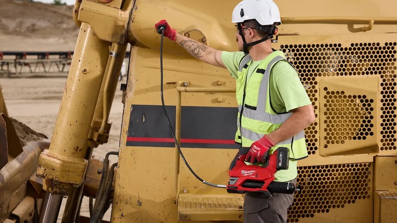 servicing machinery with M18 Fuel grease gun