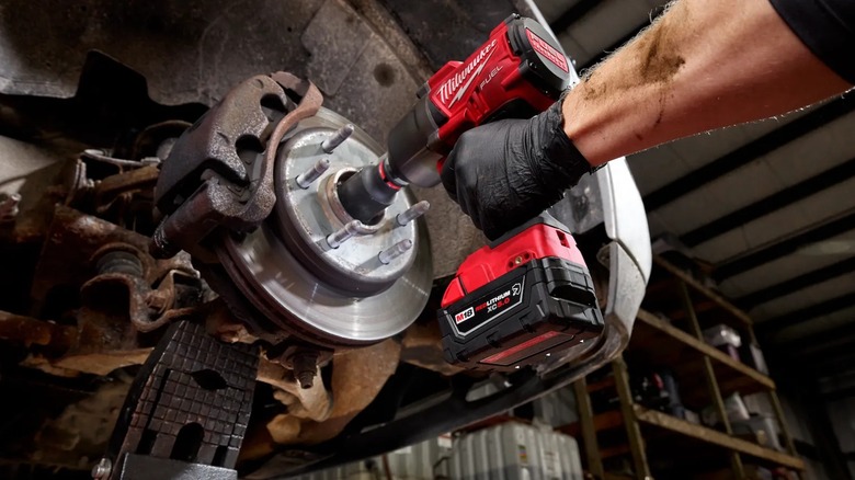 fastening car part with tool running an M18 oil resistant battery