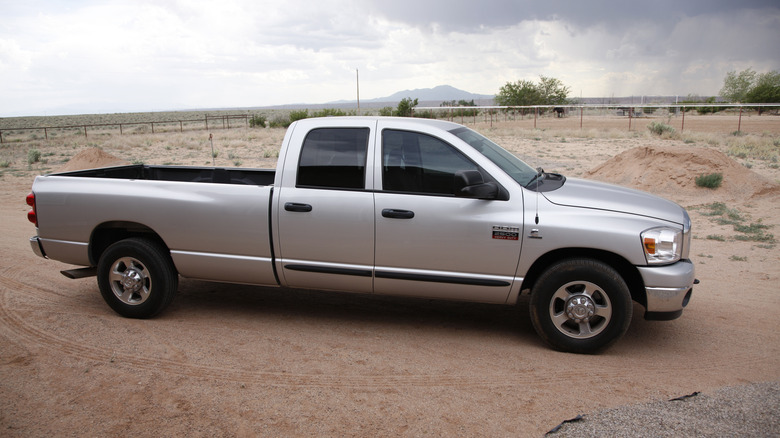 A late 2006 Dodge RAM pickup with the extended cab, silver colored, parked offroad.