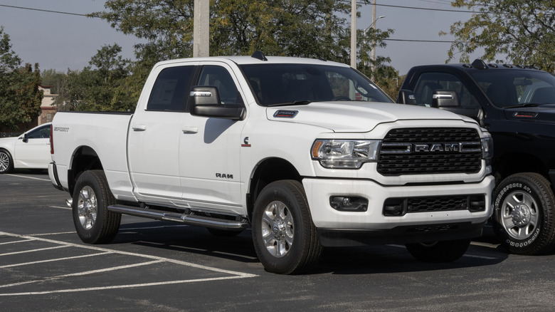 A white RAM 2500 HD Crew cab with a Cummins engine parked in a lot