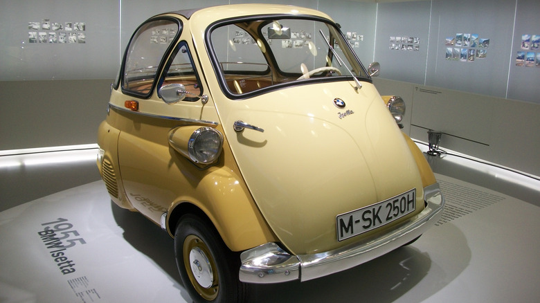 1955 BMW Isetta in two-tone yellow and cream color on display in BMW Welt in Munich