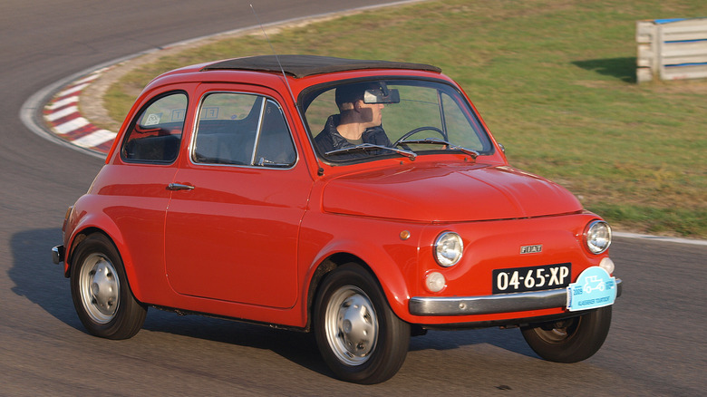 Red vintage Fiat 500 on a ractrack at a vintage car festival in the Netherlands in 2009