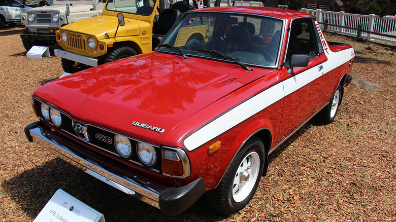 Red and white 1978 Subaru BRAT on display at outdoor car show