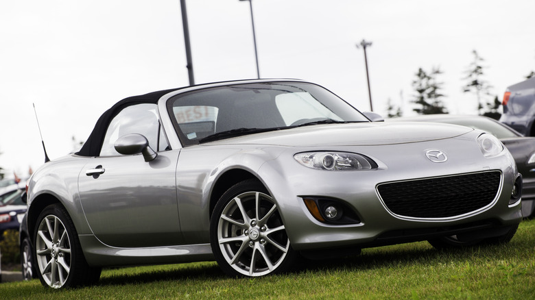 Vintage Silver Mazda MX-5 Miata on dsiplay at an outdoor car show