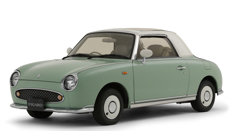 1991 Nissan Figaro in pale green and white against a blank white background
