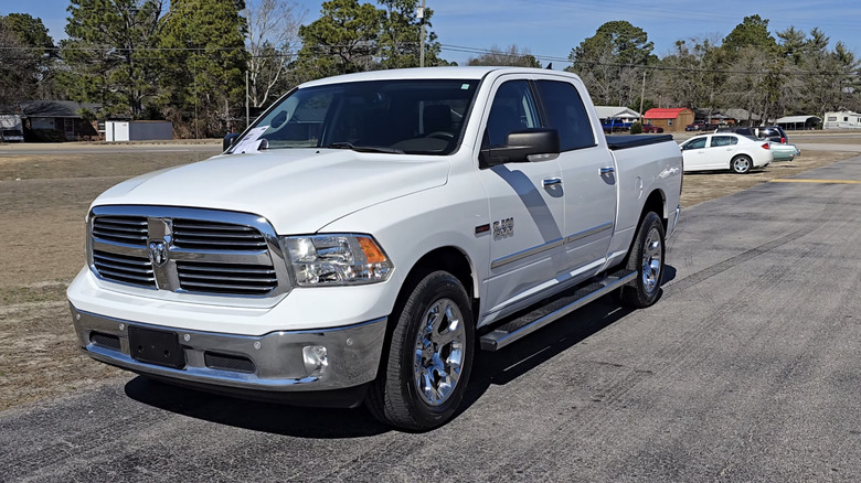 A white 2016 Ram 1500 Big Horn Eco Diesel parked on a street