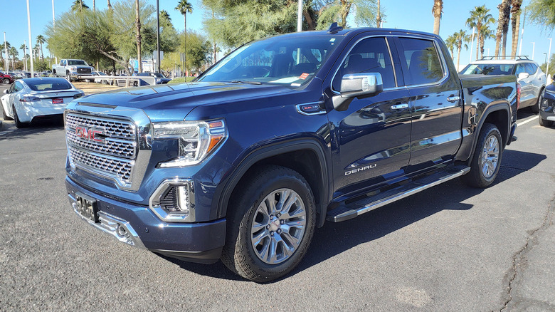 A black GMC Sierra 1500 Denali in a parking lot