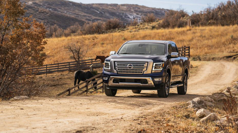 A black 2023 Nissan Titan truck on a farm