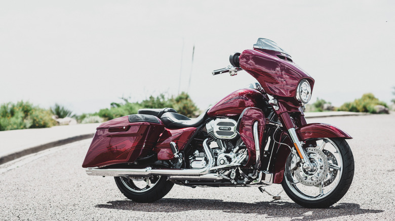 A red 2016 Harley-Davidson Street Glide CVO parked at an angle outdoors, 2016 model pictured.