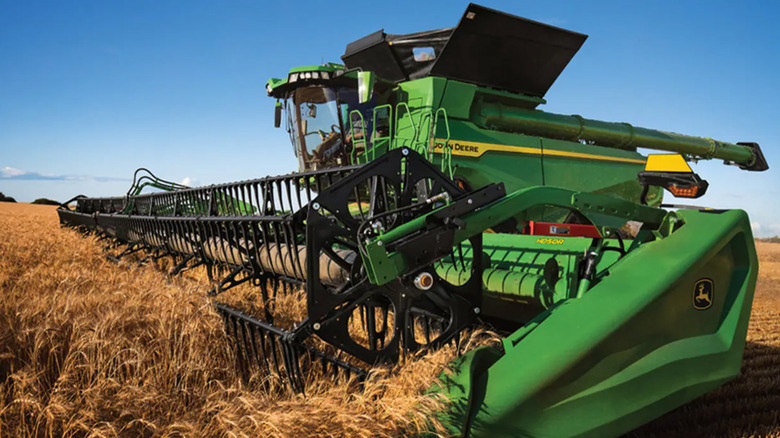 A John Deere X9 combine harvesting crops