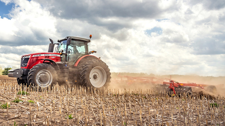 A MF 8700 S tractor tilling farmland on a cloudy day