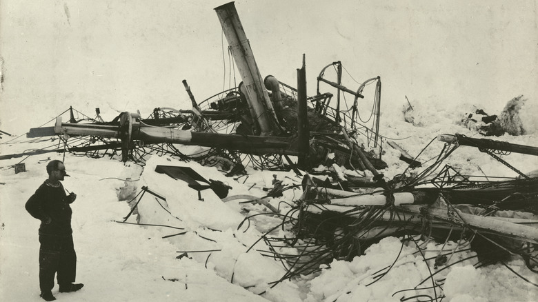 man looking at the Endurance shipwreck in Antarctica