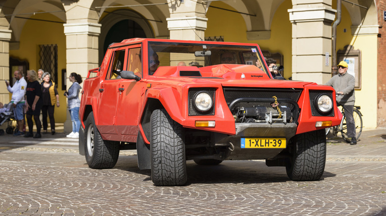 A red Lamborghini LM002 on display at a museum