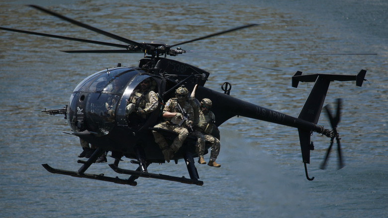 AH-6 Little Bird helicopter with troops aboard